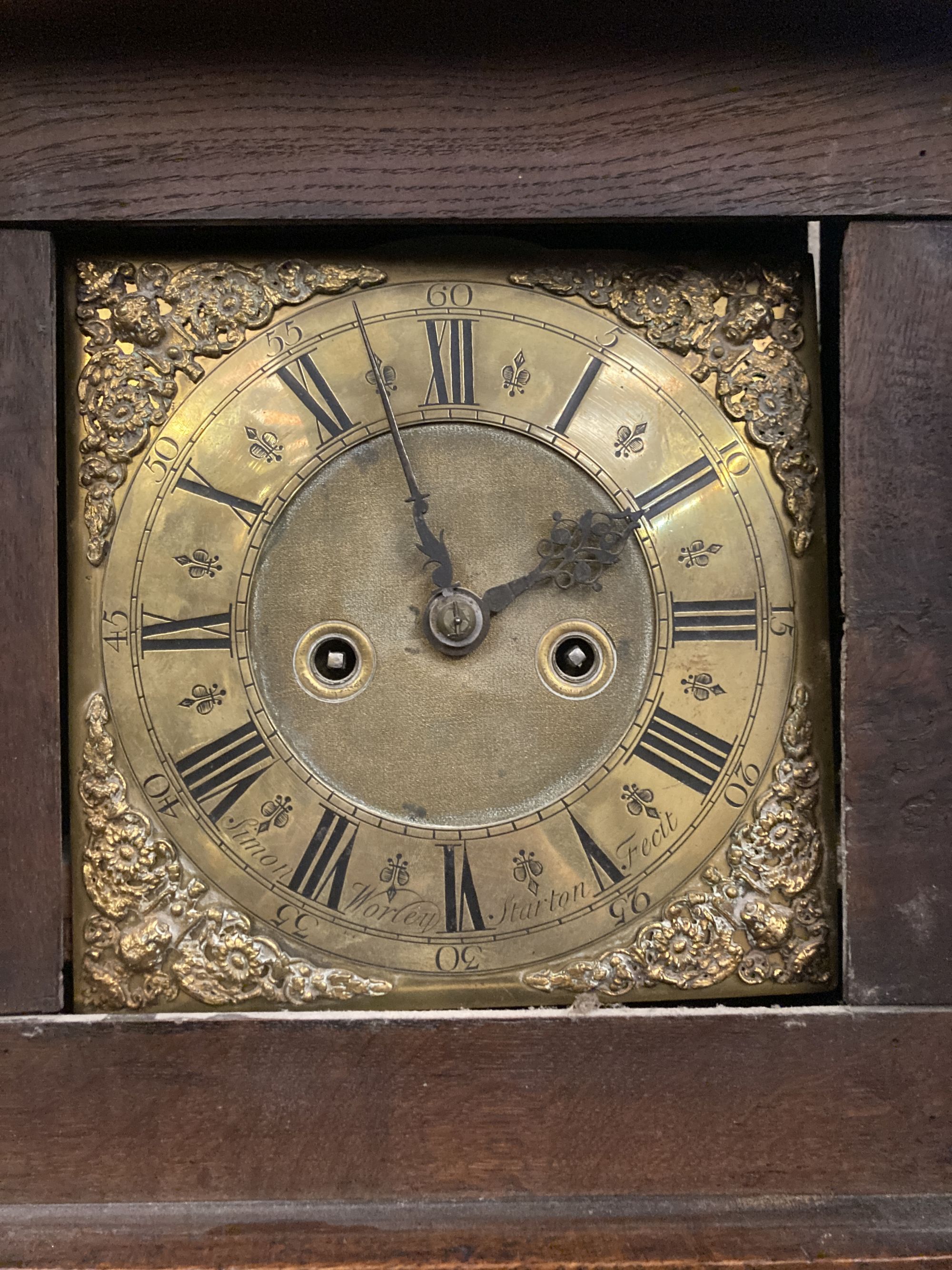 Simon Worley of Starton - an early 18th century 8 day longcase clock, contained in a later carved oak vase, height 210cm